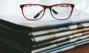 <img src="newspaper.jpg" alt="glasses on newspaper">